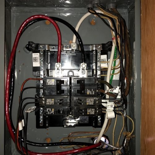 Inside of an older residential electrical panel opened for inspection in Ogden, Utah